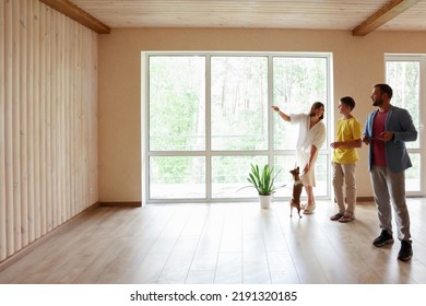 The Family Moves Into A New Apartment, Inspects A New House, Apartment, Discusses The Future Interior. Dad Mom And Son In A New Empty Apartment