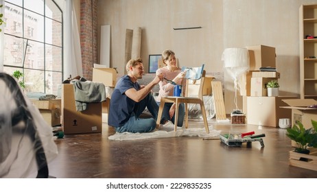 Family Moving in   Home Renovations: Couple in Love Painting Furniture Chair for Cozy Home  Boyfriend   Girlfriend Make Apartment Comfortable and Art  Color  Smiles   Happiness 