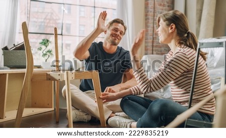 Family Moving in: Happy Couple Assembles Furniture Together, Girlfriend Boyfriend Do High Five after Successfully Doing the Job. Furniture Assembly in New Apartment for Young Partners in Love