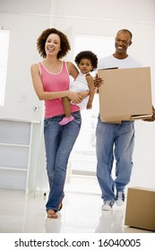 Family Moving Into New Home Smiling