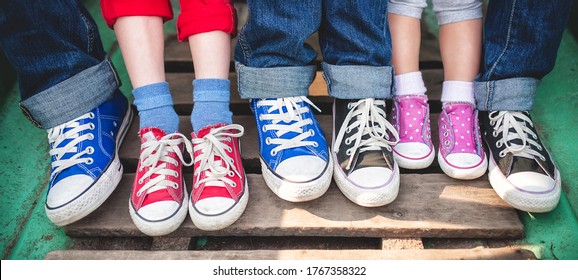 A Family In Multi-colored Sneakers, Children And Parents.