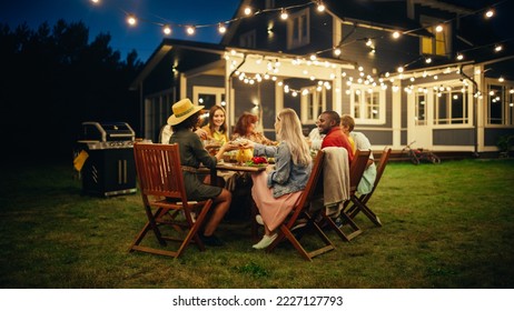 Family and Multicultural Friends Celebrating Outside at Home in the Evening. Group of Children, Adults and Old People Gathered at a Table, Having Fun Conversations. Eating Barbecue and Vegetables. - Powered by Shutterstock