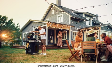 Family and Multiethnic Diverse Friends Gathering Together at a Garden Table. People Cooking Meat on a Fire Grill, Preparing Tasty Salads for a Big Family Celebration with Relatives. - Powered by Shutterstock