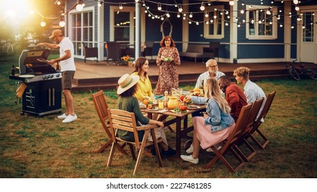 Family and Multiethnic Diverse Friends Gathering Together at a Garden Table. People Cooking Meat on a Fire Grill, Preparing Tasty Salads for a Big Family Celebration with Relatives.