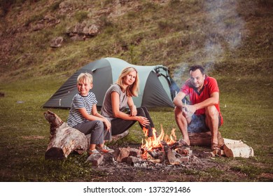 Family Near The Bonfire In The Forest