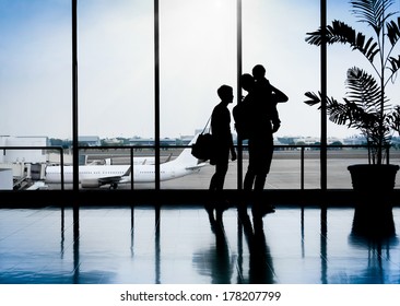 Family In A Nice Moment At Airport Waiting For Departure