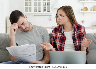 Family With No Money. Young Couple Trying To Pay Bills Online, Having Financial Problems, Worried About Troubles With Mortgage Payment To Bank And High Taxes