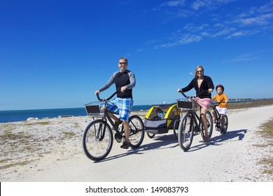 Family On A Beach Bicycle Ride Together