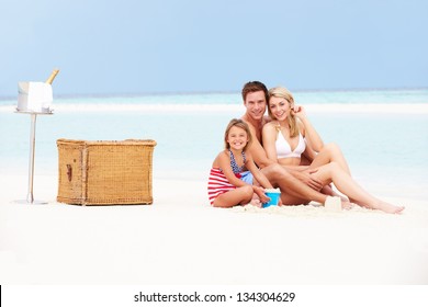 Family On Beach With Luxury Champagne Picnic