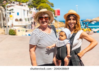 A Family On The Beach Of Sa Tuna On The Coast Of Begur In Summer, Girona On The Costa Brava Of Catalonia In The Mediterranean