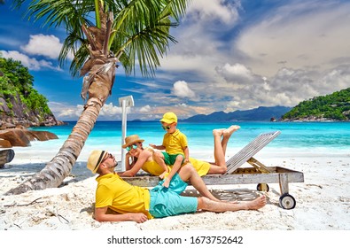 Family on beautiful Petite Anse beach, young couple with three year old toddler boy. Summer vacation at Seychelles, Mahe. - Powered by Shutterstock