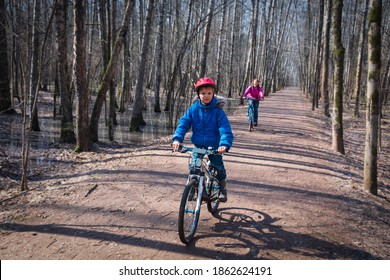 Family On Bike Ride In Spring, Mother And Son Exercise In Nature