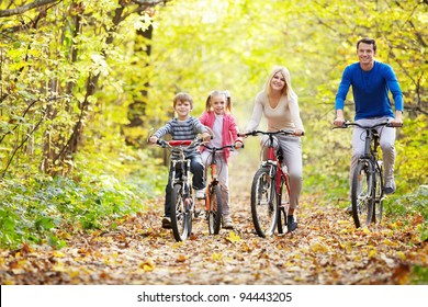 Family On Bikes In The Park