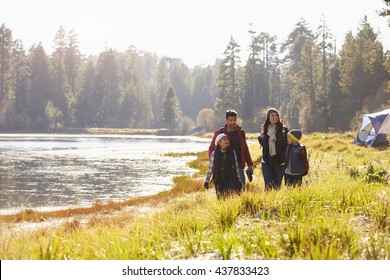 Family On Camping Trip Walk Near Lake, Looking At Each Other