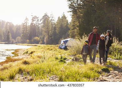 Family On A Camping Trip Walking Near A Lake