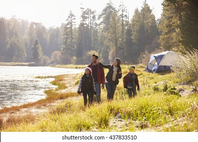 Family On A Camping Trip Walking Near A Lake Looking Away