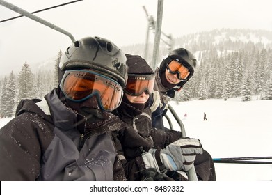 Family on Chairlift ready to ski and snowboard - see more in portfolio