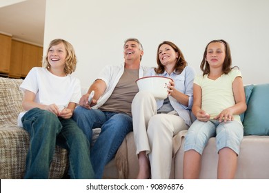 Family On The Couch Watching Tv Together