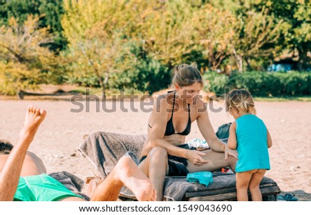 Family on deck chairs on beach - Cirali, Turkey