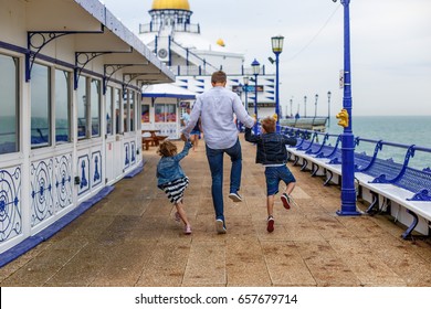 Family On Eastbourne Pier In Spring, UK