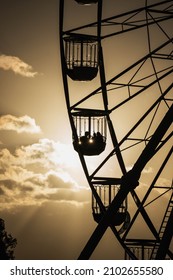 Family On Ferris Wheel On The Beach With Sun Setting And Golden Light 