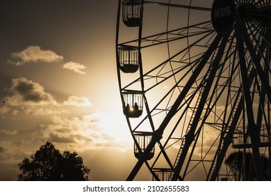 Family On Ferris Wheel On The Beach With Sun Setting And Golden Light 