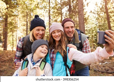 Family On Hike In A Forest Taking Selfie Group Portrait