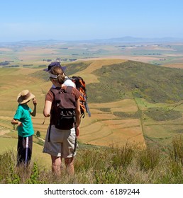 Family On Hiking Trip Looks From Mountain At Rural Landscape. Shot In Kasteelberg Mountains Nature Reserve, Near Riebeek, Western Cape, South Africa.