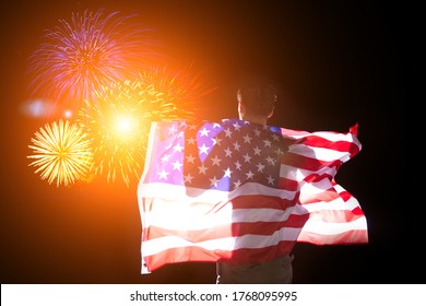 Family On Independence Day Admires The Fireworks With The American Flag In Their Hands. 4th Of July