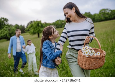 Family on interesting walk in forest, going through meadow. Mushroom, herbs medical plants or flowers picking, foraging. Concept of family ecological hobby in nature. - Powered by Shutterstock