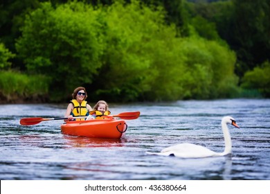 Family On Kayaks And Canoe Tour. Mother And Child Paddling In Kayak In A River On A Sunny Day. Children In Summer Sport Camp. Active Preschooler Kayaking In A Lake. Water Fun During School Vacation.