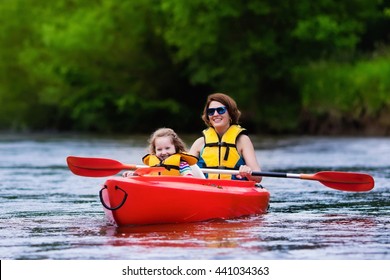 Family On Kayaks And Canoe Tour. Mother And Child Paddling In Kayak In A River On A Sunny Day. Children In Summer Sport Camp. Active Preschooler Kayaking In A Lake. Water Fun During School Vacation.