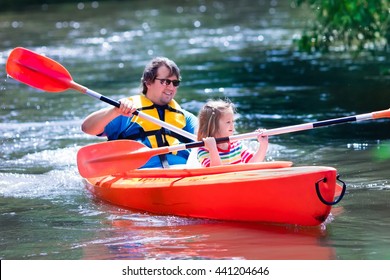 Family On Kayaks And Canoe Tour. Father And Child Paddling In Kayak In A River On A Sunny Day. Children In Summer Sport Camp. Active Preschooler Kayaking In A Lake. Water Fun During School Vacation.