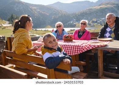 A family on a mountain vacation indulges in the pleasures of a healthy life, savoring traditional pie while surrounded by the breathtaking beauty of nature, fostering family bonds and embracing the - Powered by Shutterstock