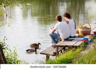 Family On Picnic Near The Lake