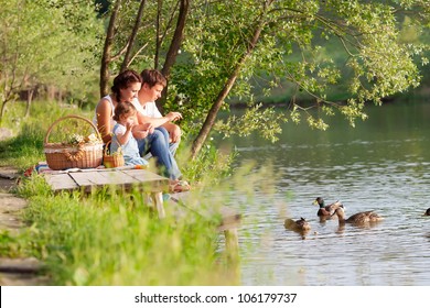 Family On Picnic Near The Lake