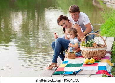 Family On Picnic Near The Lake