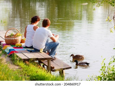 Family On Picnic Near The Lake