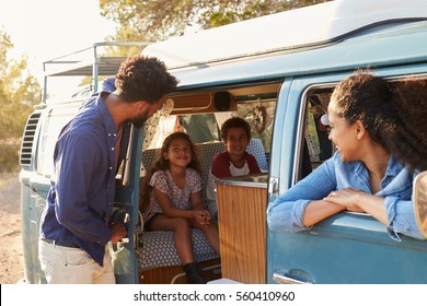 Family On A Road Trip Making A Stop In Their Camper Van