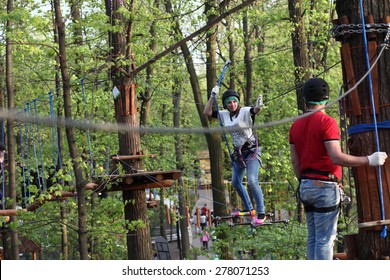 Family On A Rope Climbing In The Adventure Park