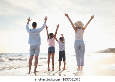 Family On Sandy Beach Near Sea, Back View. Summer Vacation