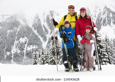 Family On Ski Holiday In Mountains