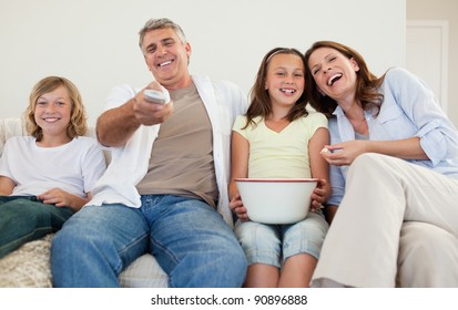 Family On The Sofa Watching Tv Together