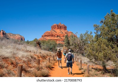 Family on spring hiking trip in red mountains. Family walking on pathway on Bell Rock Loop. Bell Rock is a butte just north of Village of Oak Creek, Arizona, south of Sedona in Yavapai County.USA. - Shutterstock ID 2170008793