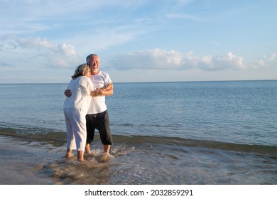 Family On Summer Beach Vacation, Healthy Older Couple Running On Sea Beach, Concept For 
Caring For The Elderly, Caregiving To Older Persons And Relations Of The Family To Support Elderly State