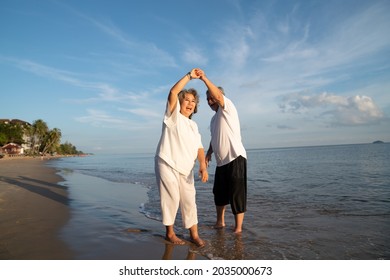 Family On Summer Beach Vacation, Healthy Older Couple Running On Sea Beach, Concept For 
Caring For The Elderly, Caregiving To Older Persons And Relations Of The Family To Support Elderly State