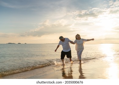 Family On Summer Beach Vacation, Healthy Older Couple Running On Sea Beach, Concept For 
Caring For The Elderly, Caregiving To Older Persons And Relations Of The Family To Support Elderly State