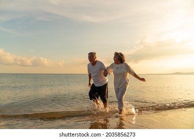 Family On Summer Beach Vacation, Healthy Older Couple Running On Sea Beach, Concept For 
Caring For The Elderly, Caregiving To Older Persons And Relations Of The Family To Support Elderly State