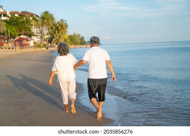 Family On Summer Beach Vacation, Healthy Older Couple Running On Sea Beach, Concept For 
Caring For The Elderly, Caregiving To Older Persons And Relations Of The Family To Support Elderly State