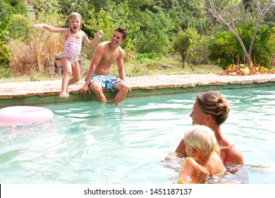 Family On Summer Holiday Villa Swimming With Mother In Water With Boy Son And Girl Diving In, Sunny Outdoors. Children And Adults On Vacation, Travel Activities Playing Leisure Recreation Lifestyle. 